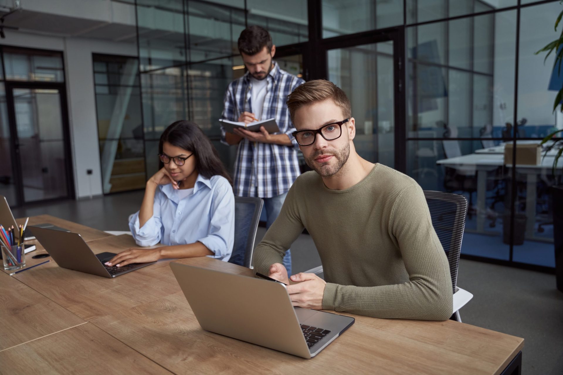 young guys are working at laptop